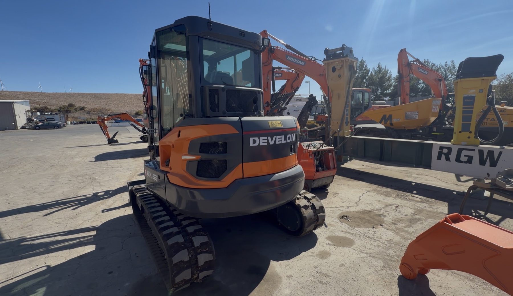 Develon DX63-7 rear view with rubber tracks
