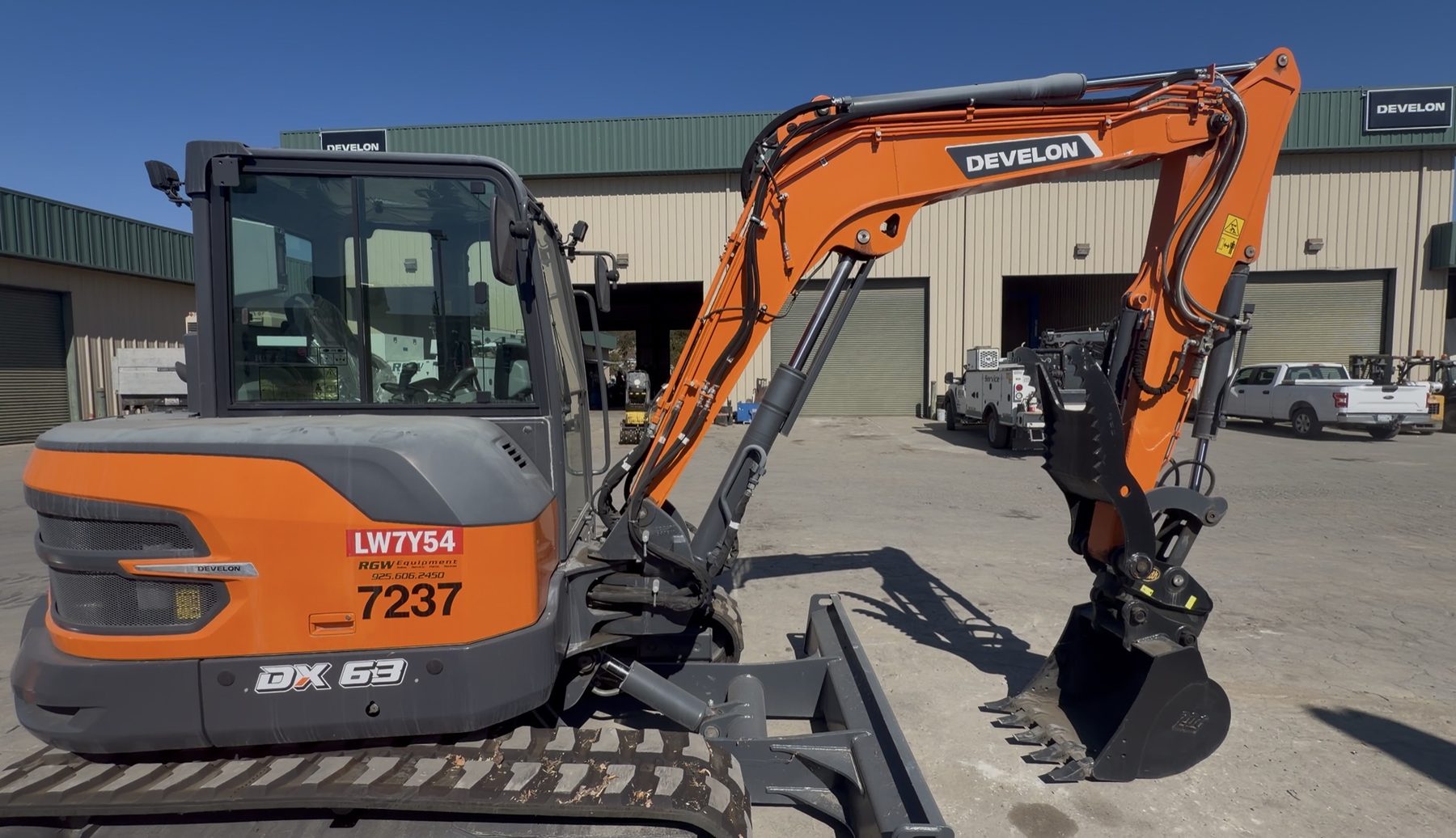 Develon DX63-7 mini excavator digging on a job site